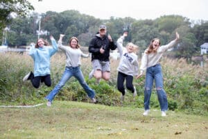 Five teens jumping in the air