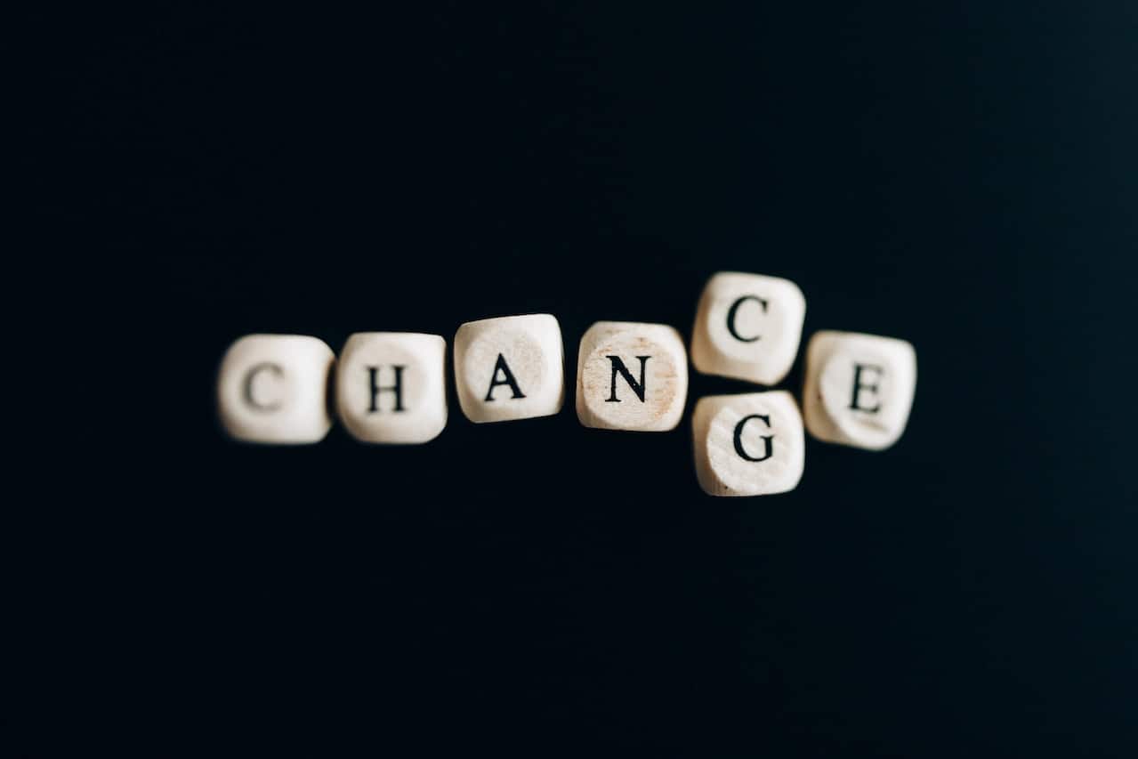 pexels-nataliya-vaitkevich-6120219 scrabble letters on a black background that spell out "chance" but with a "g" beneath the "n", so they could also spell out "change"