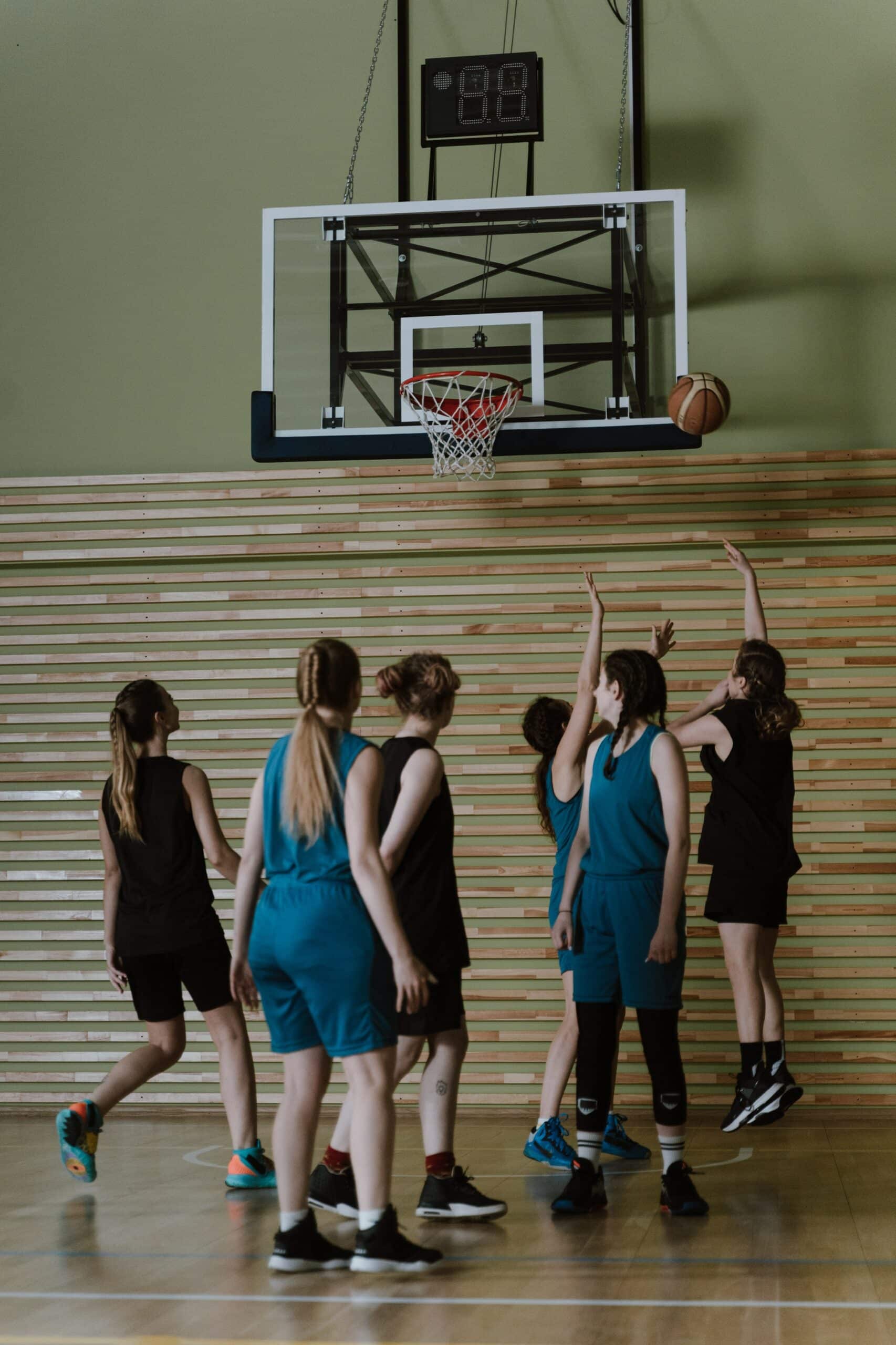 pexels-cottonbro-studio-6777164 Teen girls playing basketball, all under the hoop after a shot has been taken.