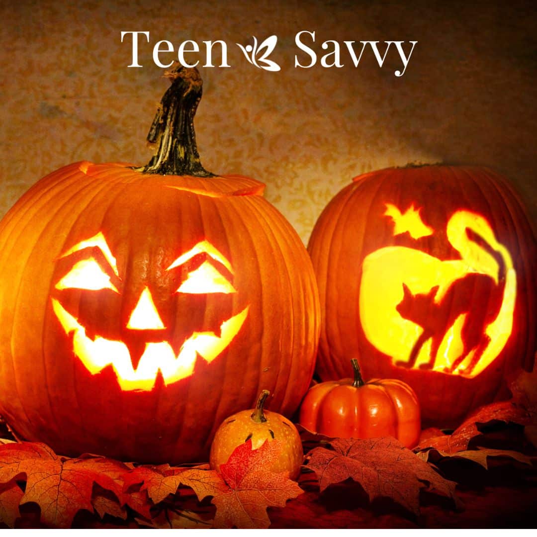 Two carved jack-o-lanterns, one with a smiling face, one with a cat arching its back.