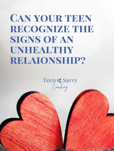 Block letters that read "Can your Teens Recognize the Signs of an Unhealthy Relationship" along with two red wooden hearts touching on a tabletop beneath the words.