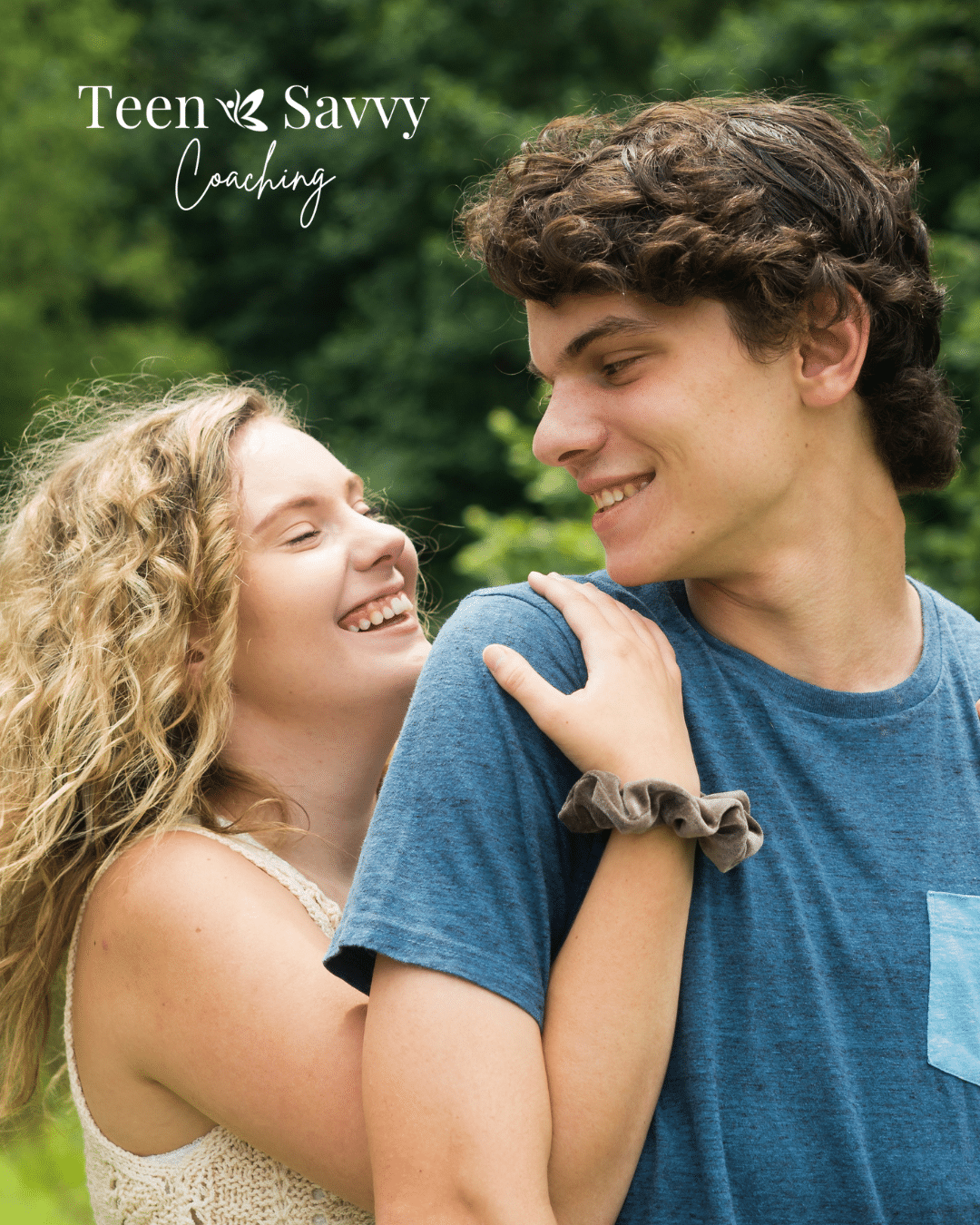 Girl and boy looking at each other. Girl is hugging the boy from behind. Teen Savvy Coaching logo in upper left corner