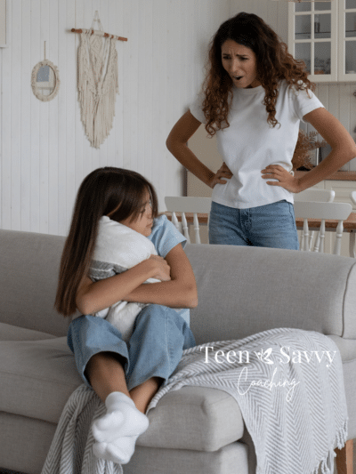 Mother behind a couch yelling at her daughter on the couch. Daughter is upset and hugging a pillow